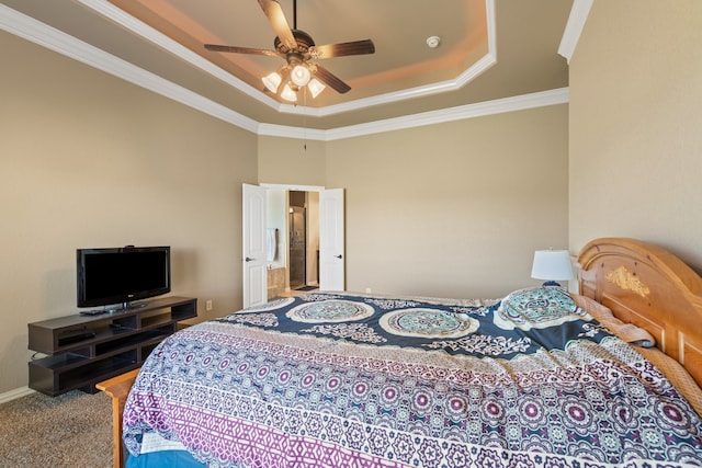 carpeted bedroom with a raised ceiling, ceiling fan, and ornamental molding