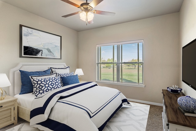 bedroom with ceiling fan and light colored carpet