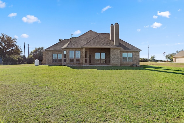 back of property featuring a lawn