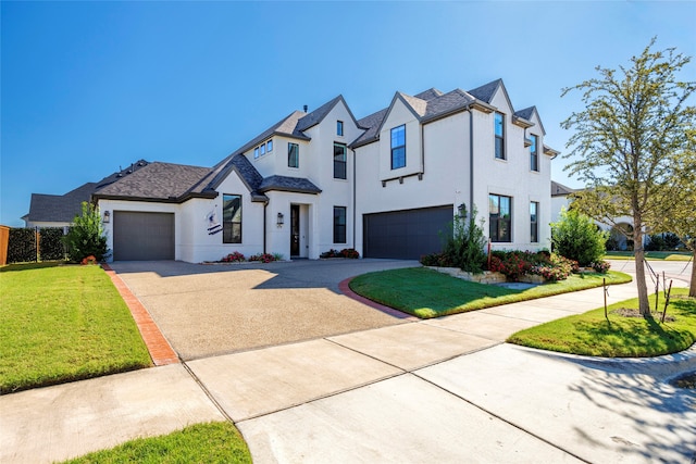 view of front of property with a garage and a front yard