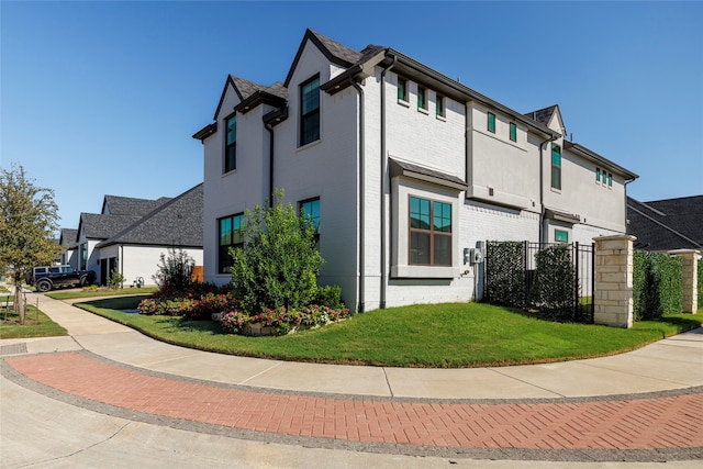 view of side of property with a lawn