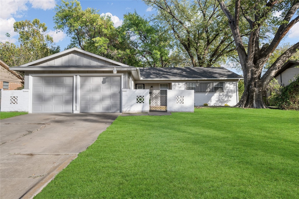 ranch-style home with a garage and a front yard