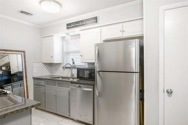 kitchen featuring white cabinets, stainless steel appliances, sink, and gray cabinetry