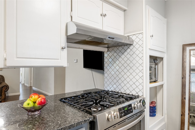 kitchen featuring white cabinets, high end stainless steel range oven, decorative backsplash, and exhaust hood