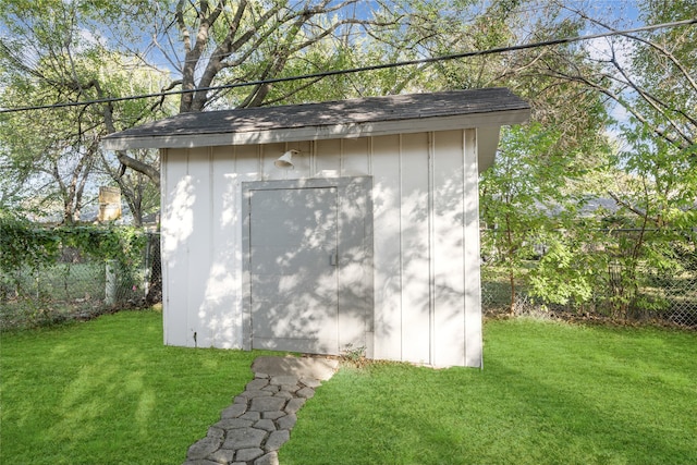 view of outbuilding with a yard