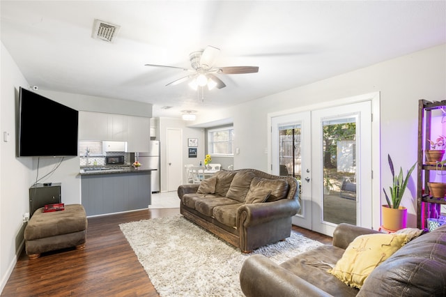 living room with french doors, dark hardwood / wood-style floors, and ceiling fan