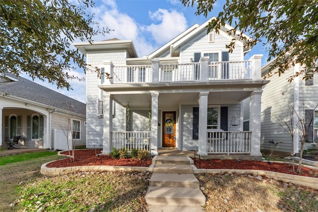 view of front of property featuring covered porch and a balcony