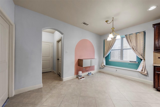 unfurnished dining area featuring light tile patterned flooring