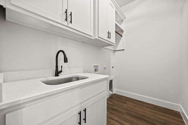 washroom featuring washer hookup, a sink, baseboards, cabinet space, and electric dryer hookup