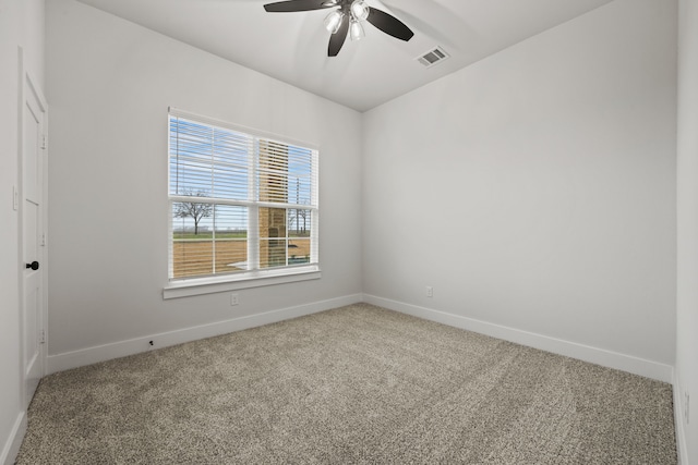 unfurnished room featuring carpet, visible vents, ceiling fan, and baseboards