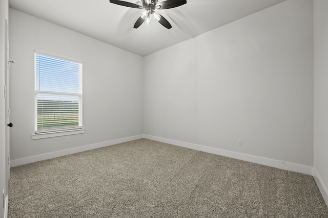 carpeted empty room featuring baseboards and a ceiling fan