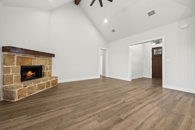 unfurnished living room with beam ceiling, a fireplace, visible vents, wood finished floors, and baseboards