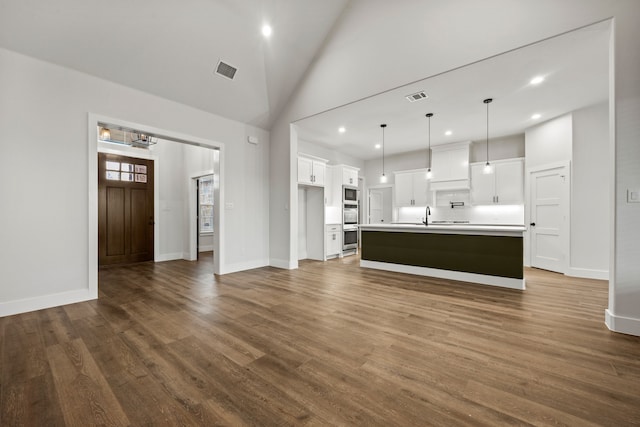 unfurnished living room featuring a sink, high vaulted ceiling, wood finished floors, and visible vents