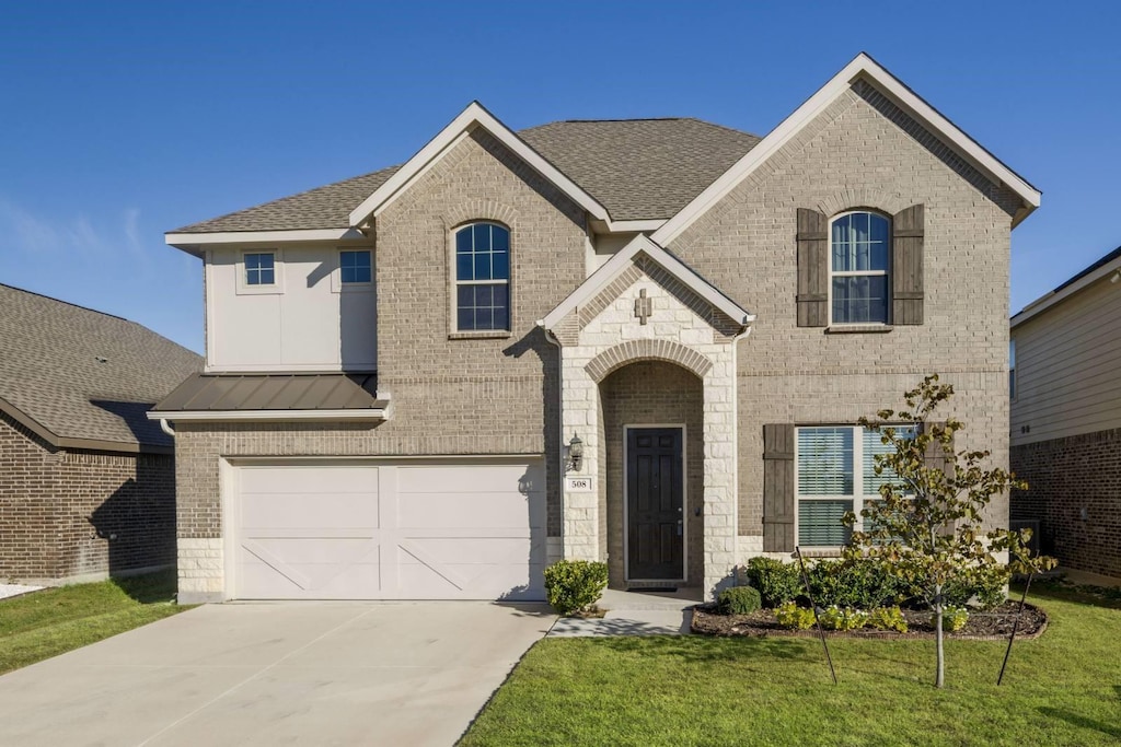 french country inspired facade with a front lawn and a garage