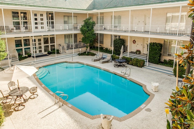 community pool featuring a patio area