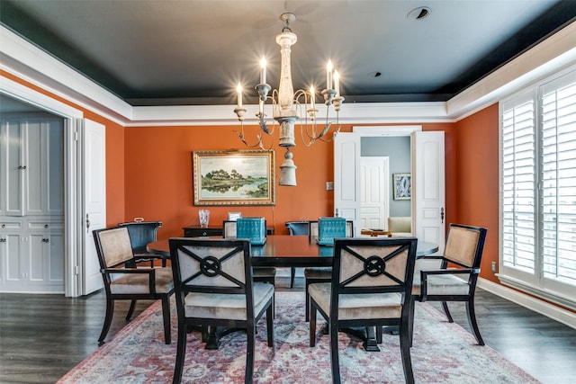 dining area featuring dark hardwood / wood-style floors and an inviting chandelier