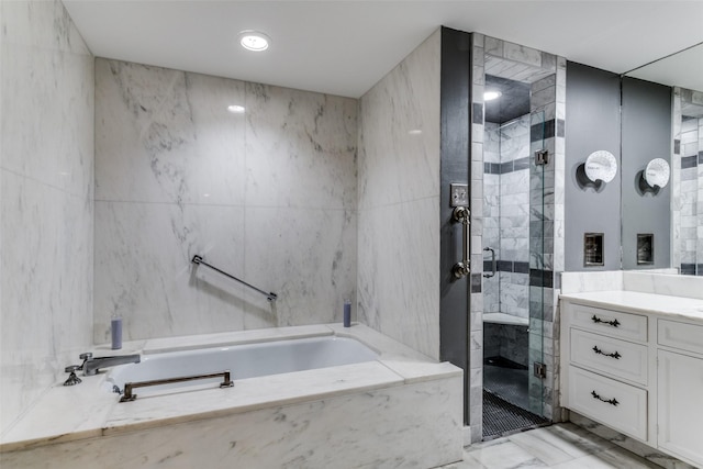 bathroom featuring tile walls, vanity, and independent shower and bath