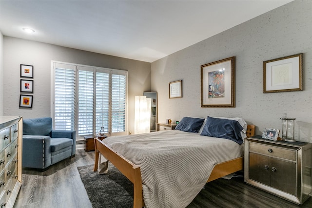 bedroom with dark hardwood / wood-style flooring