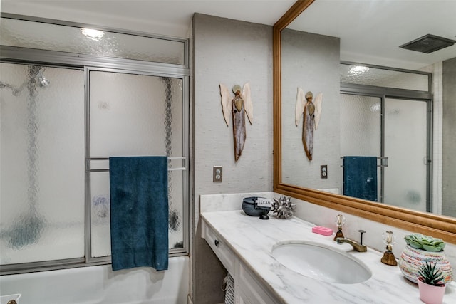 bathroom featuring shower / bath combination with glass door and vanity