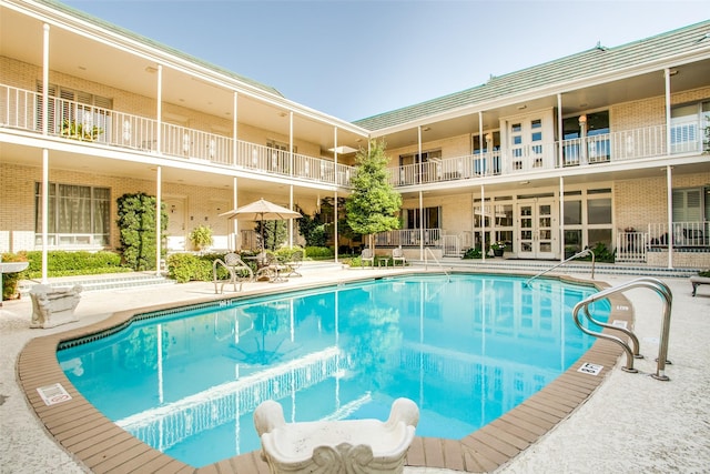 view of swimming pool featuring a patio area