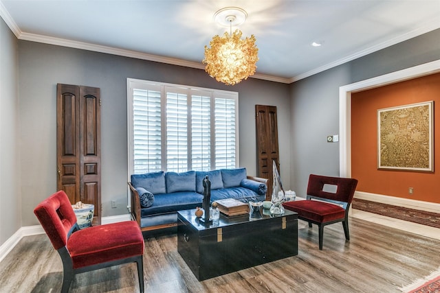 living room with an inviting chandelier, ornamental molding, and hardwood / wood-style floors