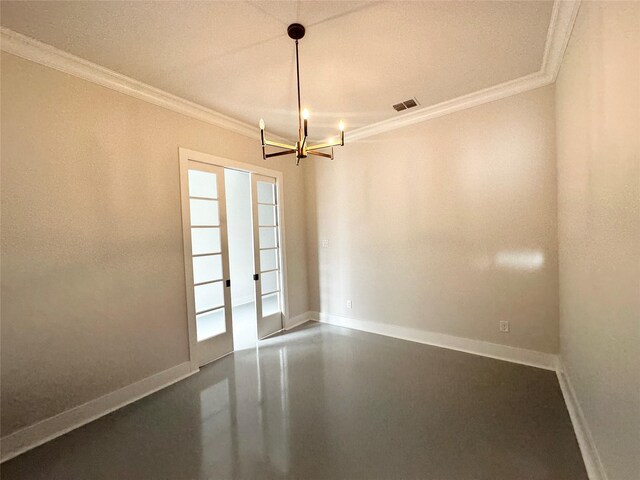 spare room featuring a notable chandelier, crown molding, and french doors