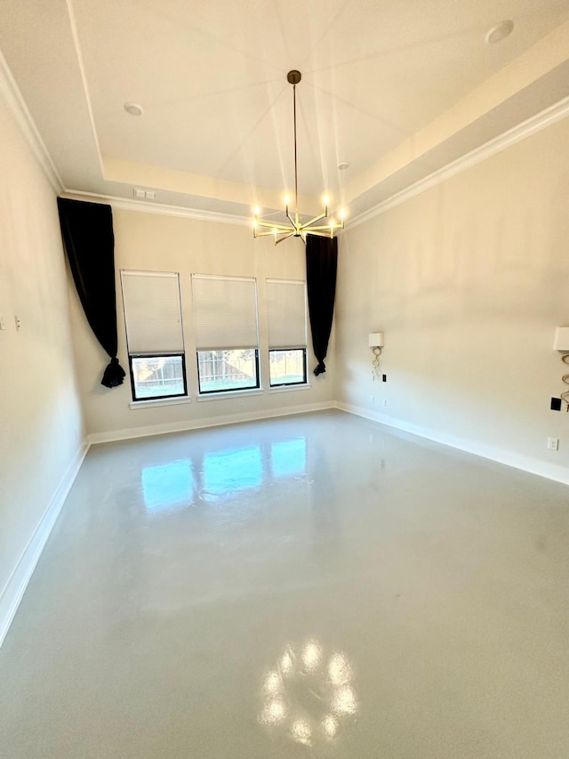 empty room with concrete floors, an inviting chandelier, a raised ceiling, and ornamental molding