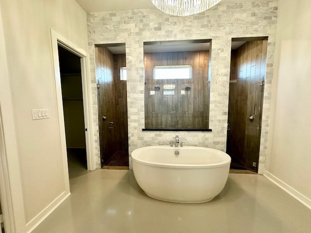 bathroom with concrete flooring and separate shower and tub