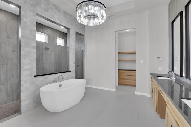 1719 Silver Marten Trl, Arlington, TX 76005 - full bath featuring baseboards, a chandelier, a soaking tub, a walk in shower, and vanity