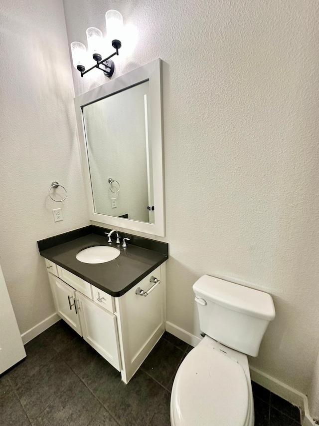 bathroom featuring tile patterned floors, vanity, and toilet