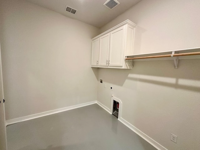 laundry area featuring hookup for an electric dryer, gas dryer hookup, and cabinets