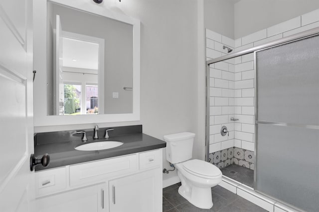 1719 Silver Marten Trl, Arlington, TX 76005 - bathroom featuring a shower stall, tile patterned flooring, vanity, and toilet