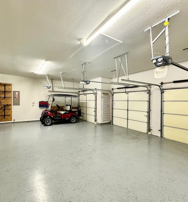 garage featuring electric panel and a garage door opener