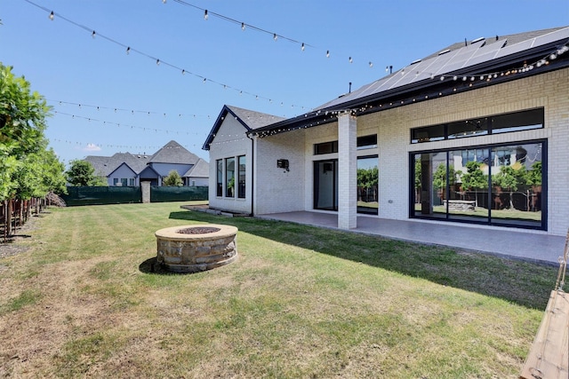 1719 Silver Marten Trl, Arlington, TX 76005 - back of house with brick siding, a fenced backyard, an outdoor fire pit, and a yard