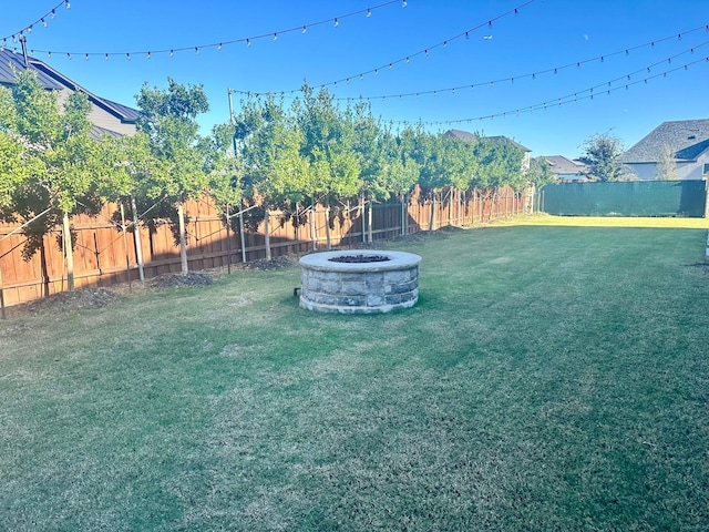 view of yard featuring an outdoor fire pit