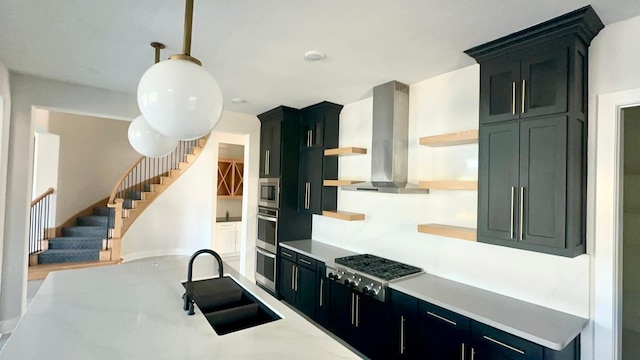 kitchen with hanging light fixtures, sink, exhaust hood, and appliances with stainless steel finishes