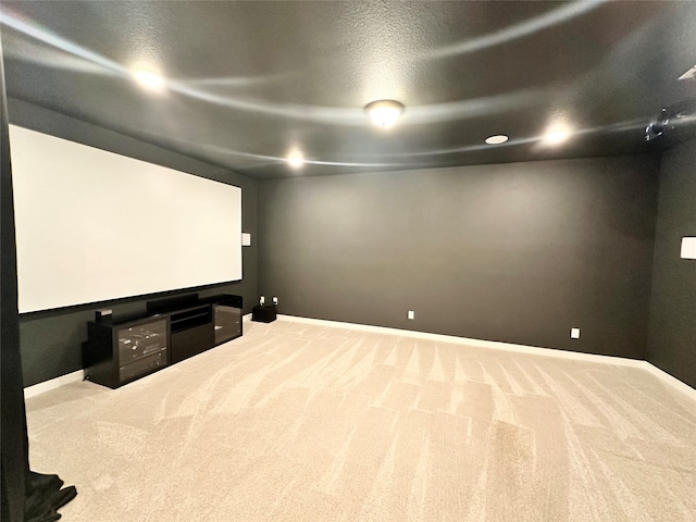 carpeted cinema featuring a textured ceiling