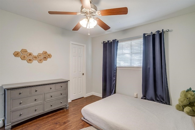 bedroom featuring ceiling fan and dark hardwood / wood-style flooring