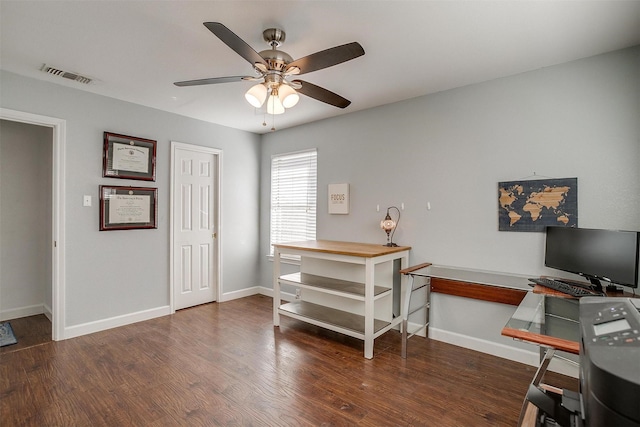 home office with dark wood-type flooring and ceiling fan