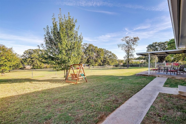 view of yard featuring a playground and a patio