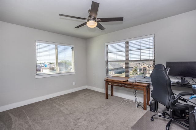 office area featuring light carpet and ceiling fan