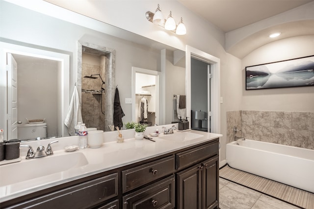 bathroom featuring toilet, vanity, tile patterned flooring, and a bathing tub