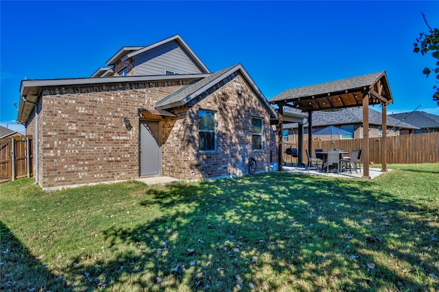 back of property with a patio and a yard