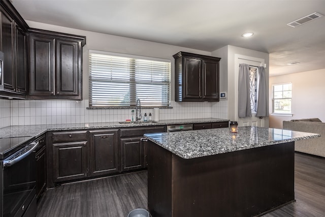 kitchen featuring appliances with stainless steel finishes, sink, dark hardwood / wood-style flooring, and tasteful backsplash