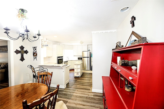 kitchen featuring light stone counters, white cabinetry, appliances with stainless steel finishes, dark hardwood / wood-style floors, and sink