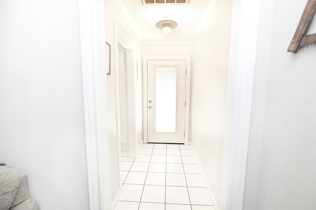 entryway featuring light tile patterned flooring and crown molding