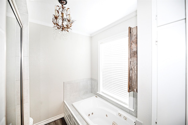 bathroom with wood-type flooring, toilet, a notable chandelier, tiled tub, and ornamental molding