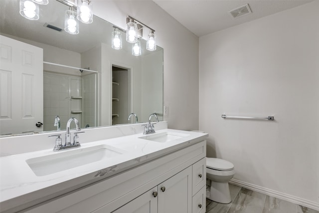 bathroom with hardwood / wood-style floors, vanity, toilet, and a shower