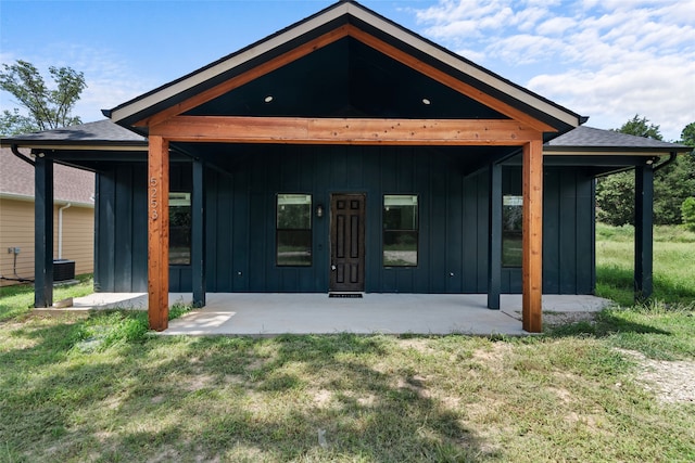 rear view of house featuring a yard and a patio