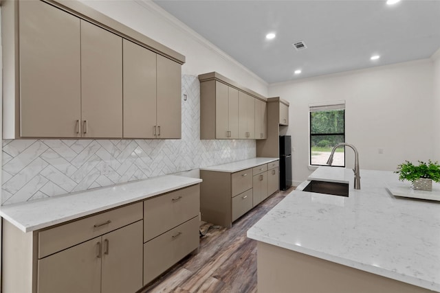 5253 Bill Cody Cir, Log Cabin, TX 75148 - kitchen with a sink, ornamental molding, light stone countertops, wood finished floors, and tasteful backsplash